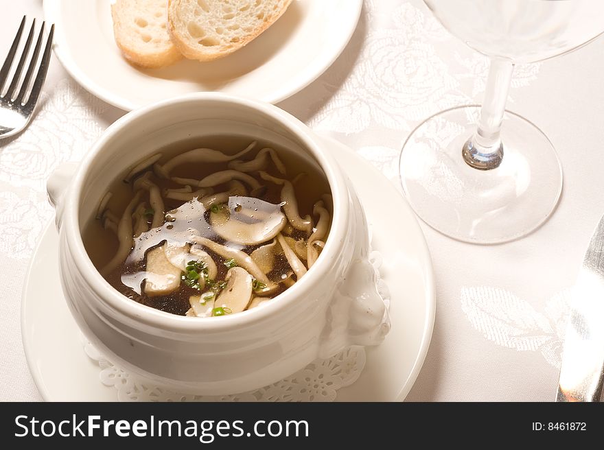 French mushroom soup served with sliced bread.