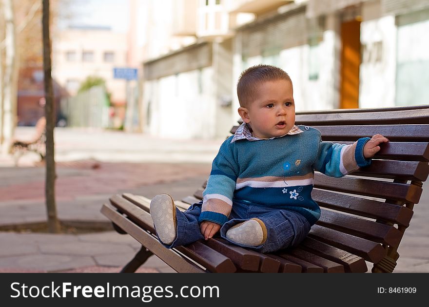 Sitting young boy on the park