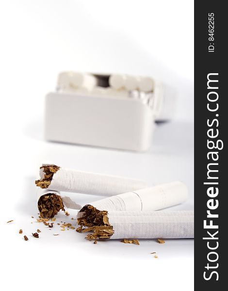 Broken cigarettes on white backgrounnd