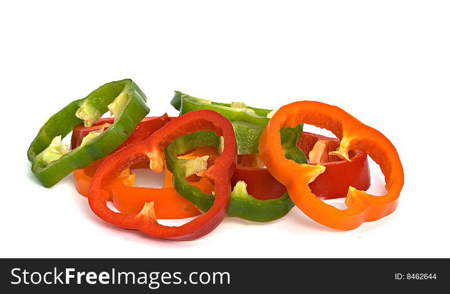 Longitudinal sections of green, yellow and red sweet peppers isolated on white background. Longitudinal sections of green, yellow and red sweet peppers isolated on white background