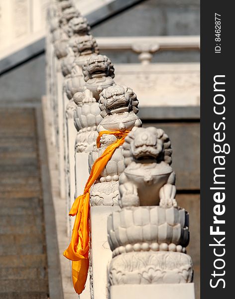 One of stone lions, which stand the side of stair to the temple, was tied a orange Hada, a silk band which symbols happiness and luck in Buddhism. One of stone lions, which stand the side of stair to the temple, was tied a orange Hada, a silk band which symbols happiness and luck in Buddhism.