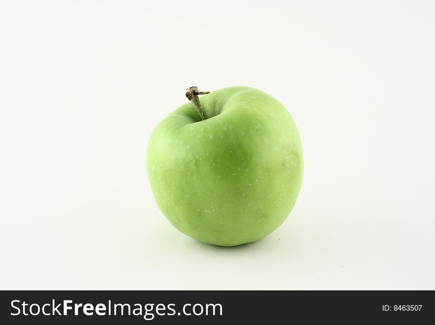 A fresh green apple on a white background. A fresh green apple on a white background