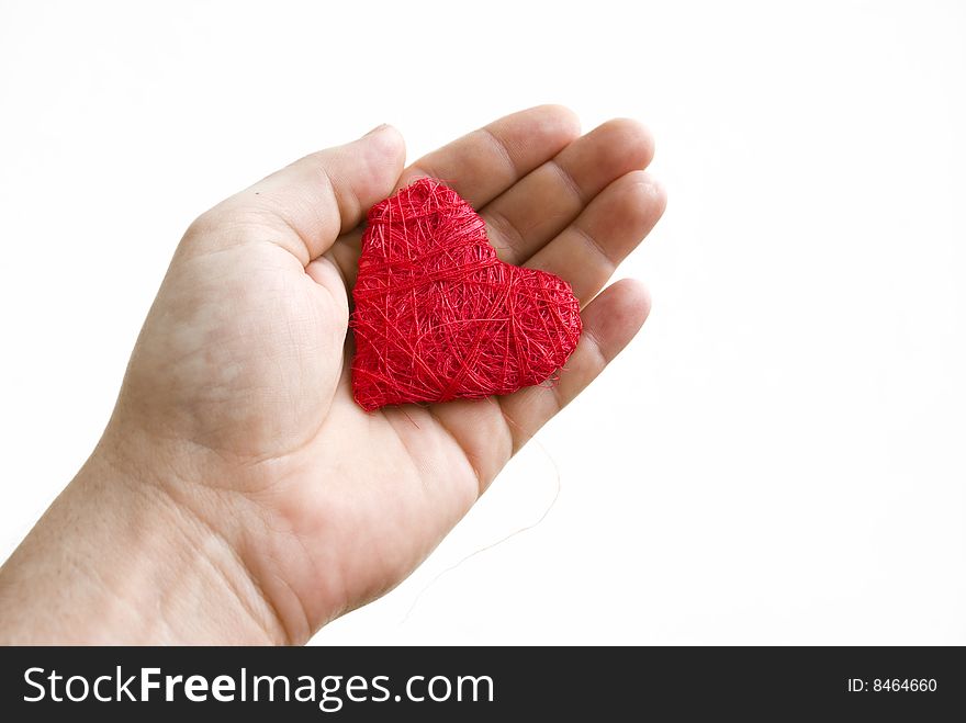 Reds heart on palm on white background.