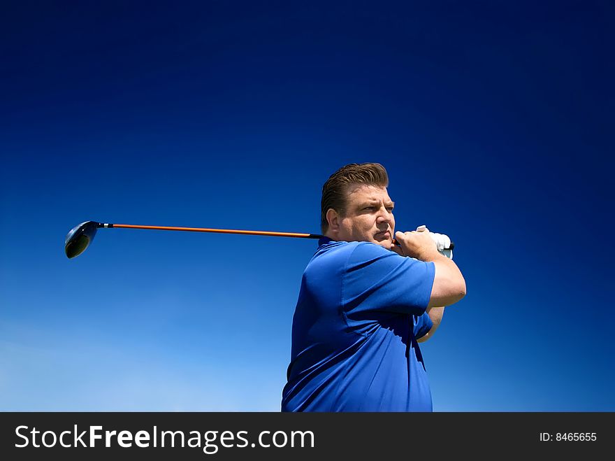 An image of a man swinging a golf club after putting. An image of a man swinging a golf club after putting