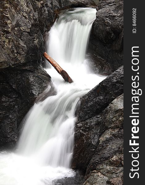 A fallen tree stuck in a waterfall in twin falls park Washington. A fallen tree stuck in a waterfall in twin falls park Washington