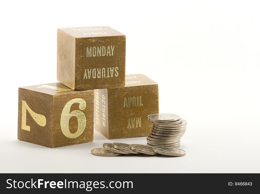 Date blocks showing the start of the tax year 2009 with a pile of coins. Date blocks showing the start of the tax year 2009 with a pile of coins