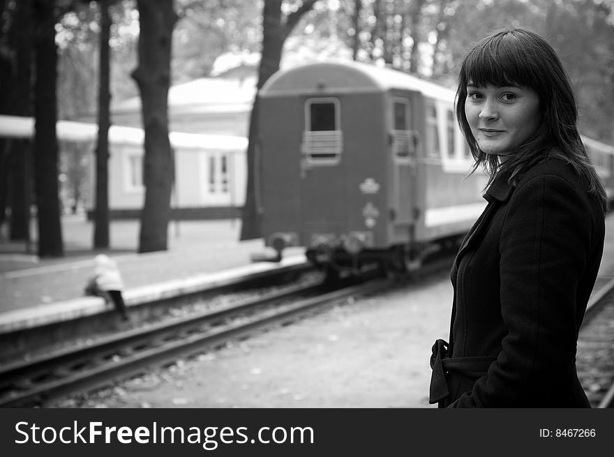 Caucasian young woman at the station. Black and white photo