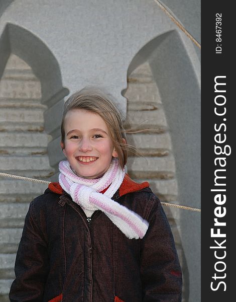 Teenage girl smiling before a small tender boat. Teenage girl smiling before a small tender boat