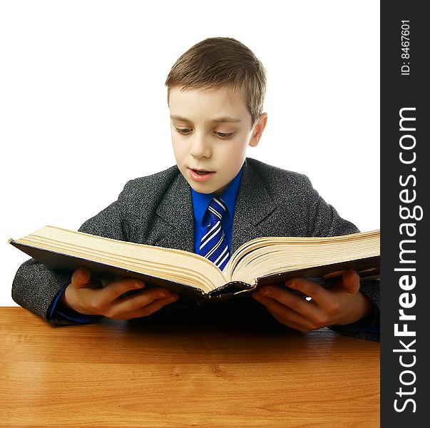 Schoolboy in a gray coat with a blue tie with an old book