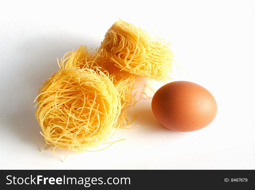 Pasta and egg on white background