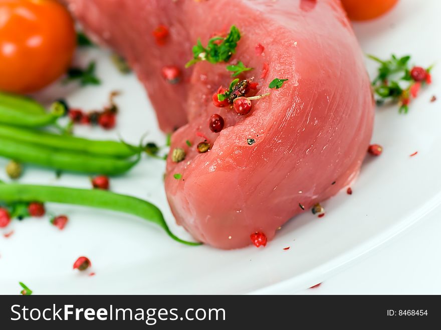 A pork fillet-tenderloin , raw.