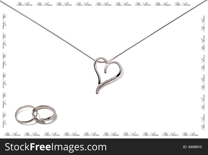 Wedding rings and chain with heart in form of post envelop. There is a lot place for text. Isolated on white. Wedding rings and chain with heart in form of post envelop. There is a lot place for text. Isolated on white