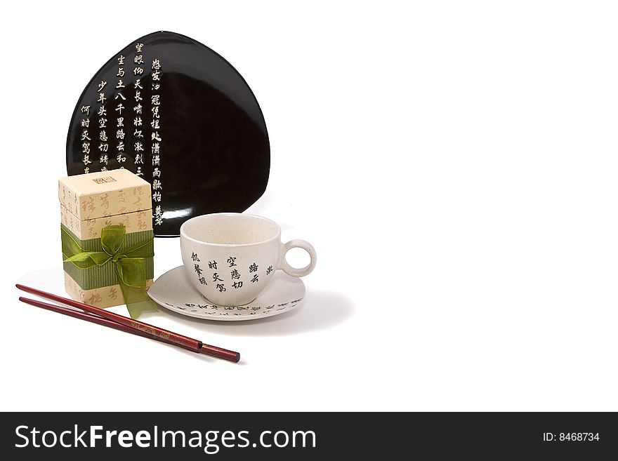 Tea-things in asian style with hieroglyphics. Isolated on white. Path included