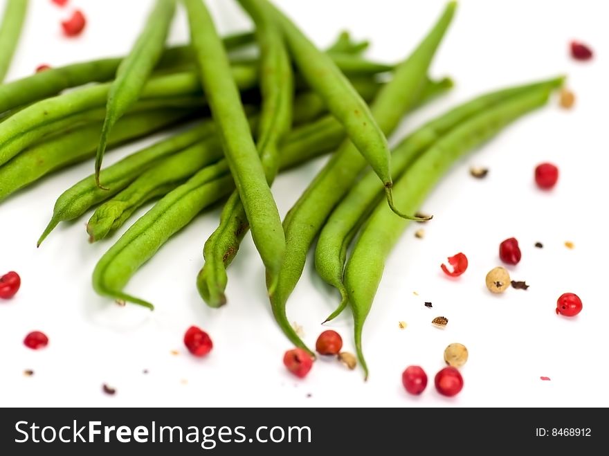 fresh green beans with grains of red pepper.