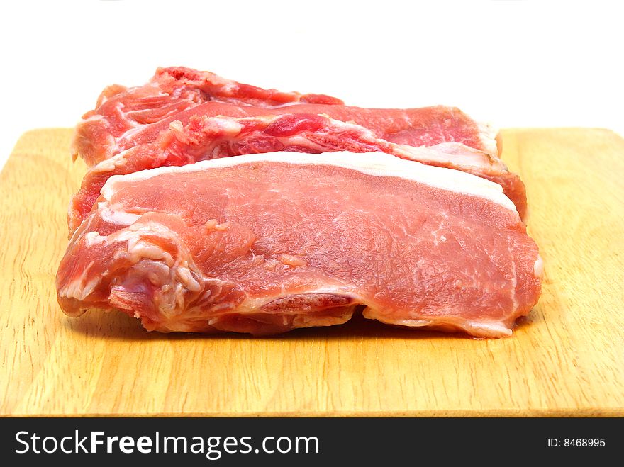 Pieces of crude pork. White background.