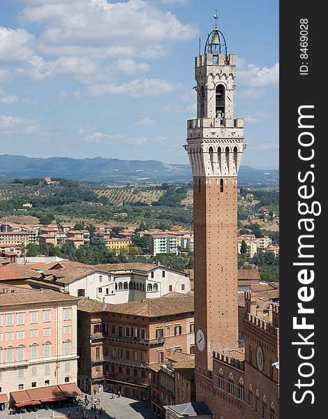 The Torre del Mangia, Sienna against a cloudy blue sky