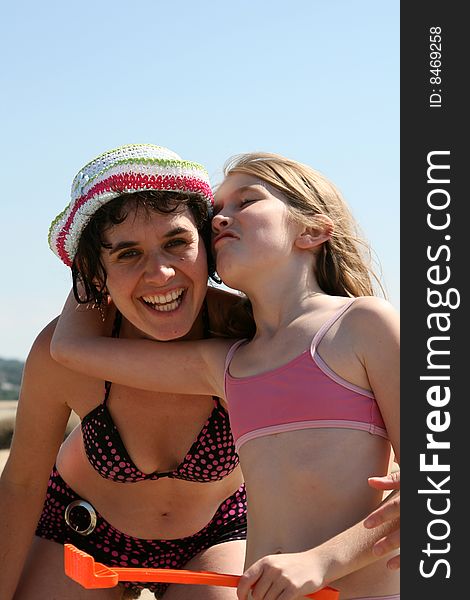 Mother and daughter playing together at the beach. Mother and daughter playing together at the beach