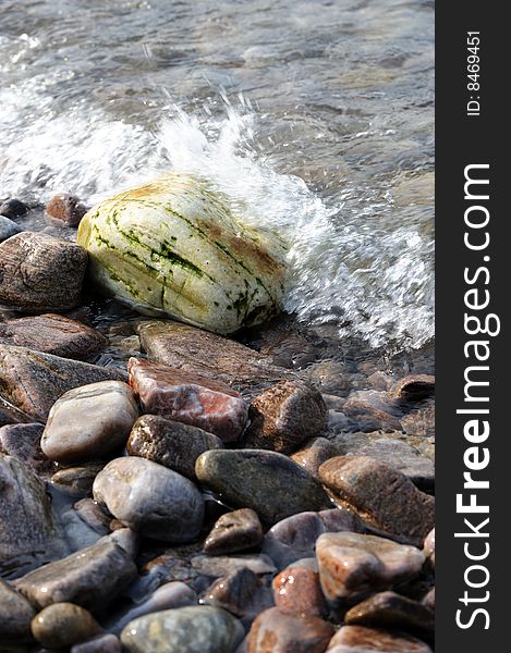 Pebbles on side of sea, spoondrift