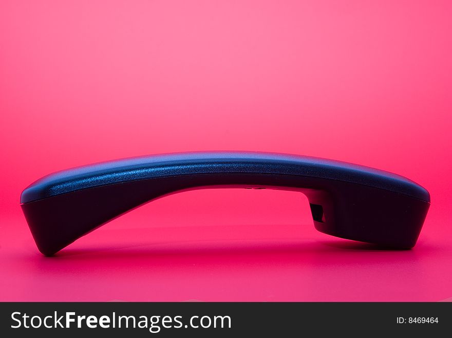 Phone handset isolated on pink background. Phone handset isolated on pink background