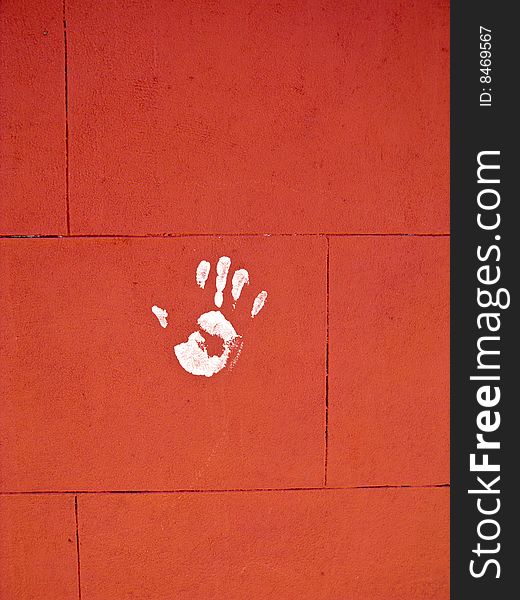 White hand print on red brick wall. White hand print on red brick wall