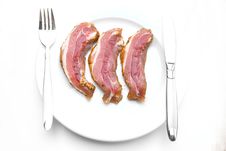 Fresh Bacon Slices Laying On White Plate Stock Images