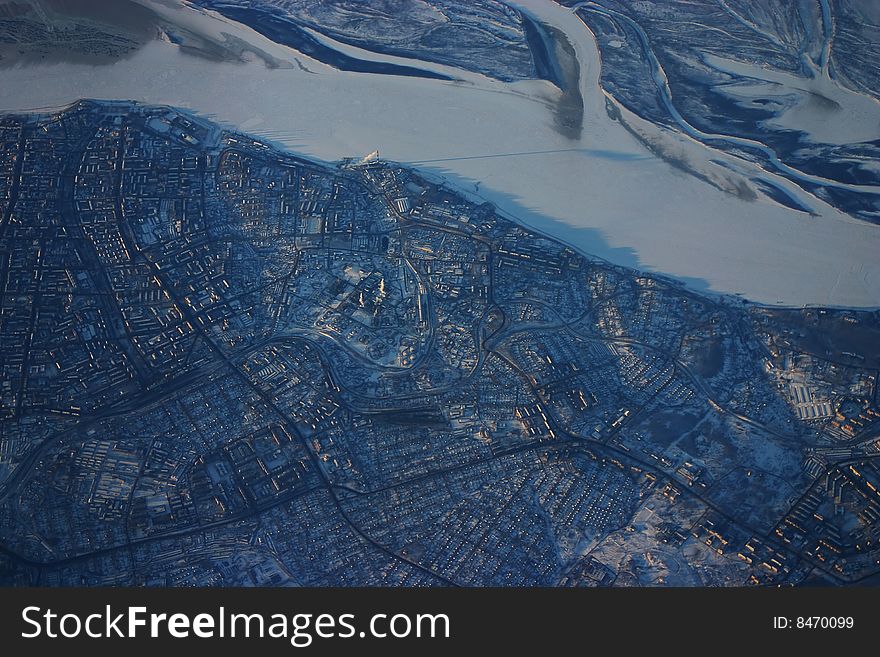 Aerial photo of frozen river and city in Siberia. Aerial photo of frozen river and city in Siberia