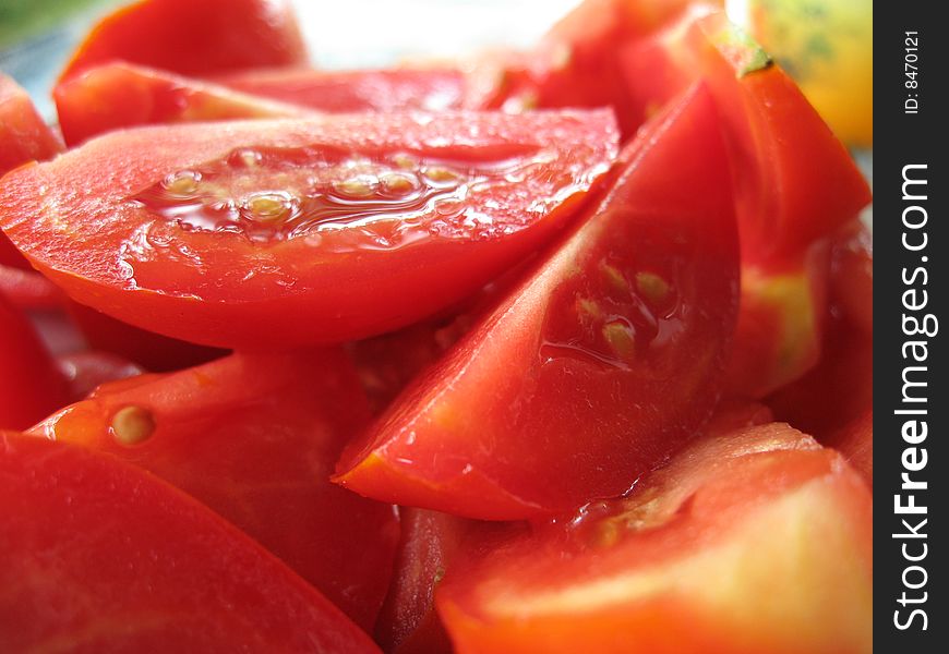 The tasty juicy tomatoes cut on a plate. The tasty juicy tomatoes cut on a plate