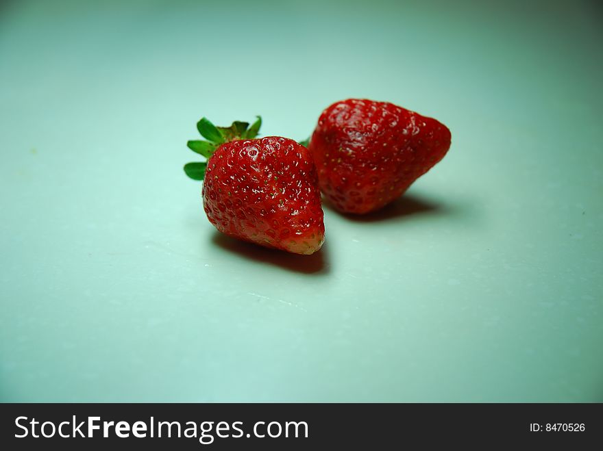 Two strawberrys on a table