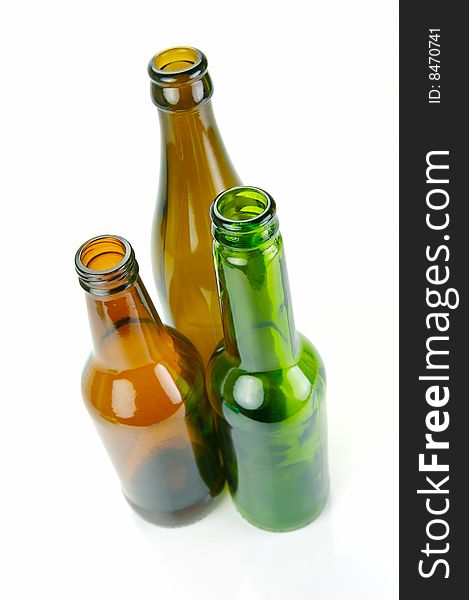 Empty beer bottles isolated against a white background