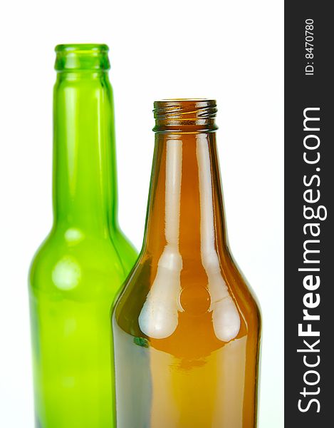 Empty beer bottles isolated against a white background