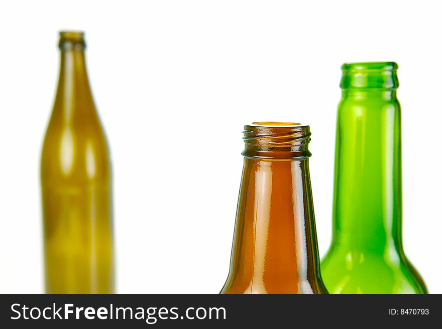 Empty beer bottles isolated against a white background