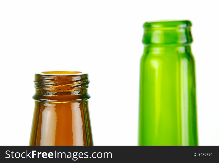 Empty beer bottles isolated against a white background