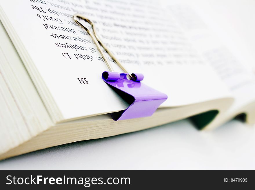 Book with paper clip isolated on white background. Book with paper clip isolated on white background