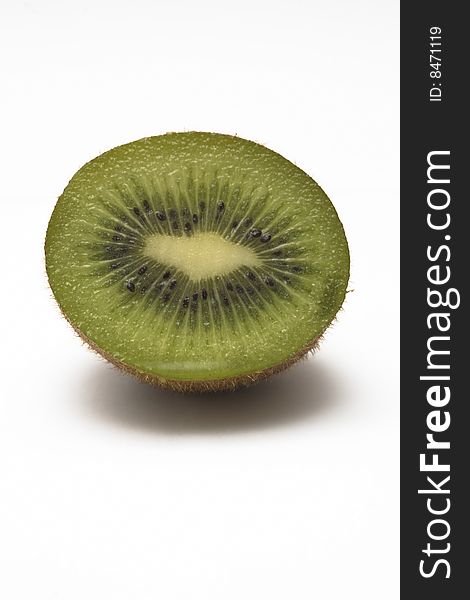 A kiwi, cut in half, isolated on a white background. A kiwi, cut in half, isolated on a white background.