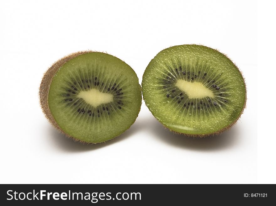 A kiwi, cut in half, isolated on a white background. A kiwi, cut in half, isolated on a white background.