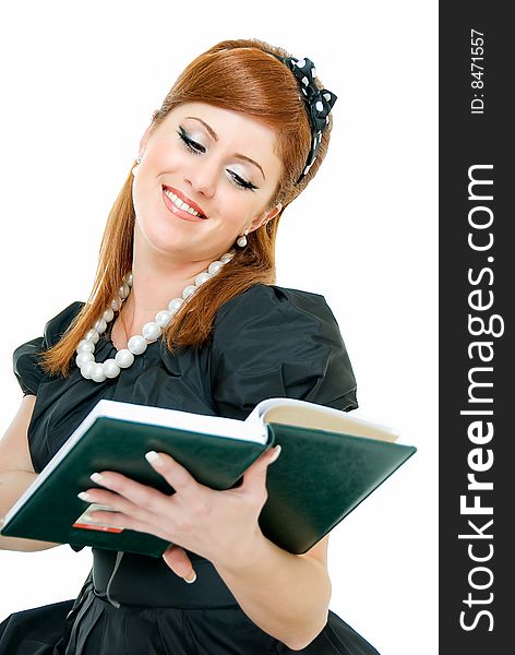 Young pretty contented redheaded woman reads something