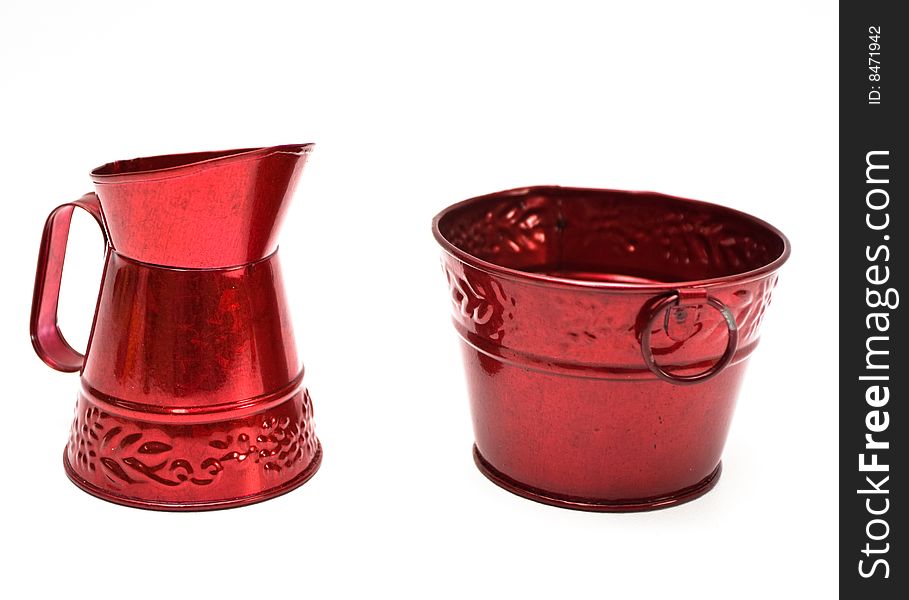 Two miniature red metal buckets on white background. Two miniature red metal buckets on white background.