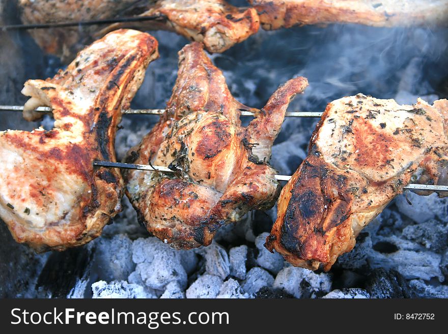 Barbecue with pork chops on the charcoal.