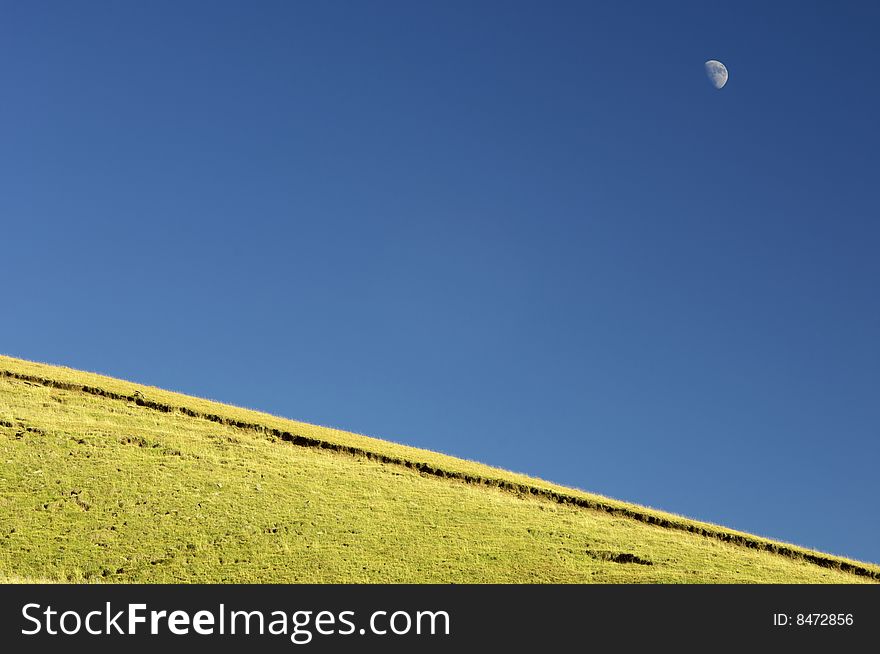 Meadow and moon in Pirineo Mountains; Huesca; Spain