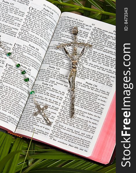 Close up of bible with rosary and crucifix with palm leaves. Close up of bible with rosary and crucifix with palm leaves