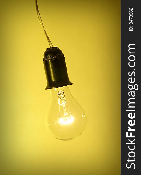 Photo of light bulb on yellow background