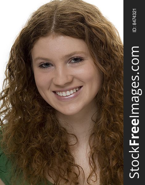 Attractive teenager with red curly hair, portrait against a white background