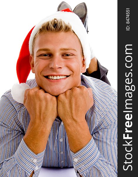 Happy laying man with christmas hat against white background