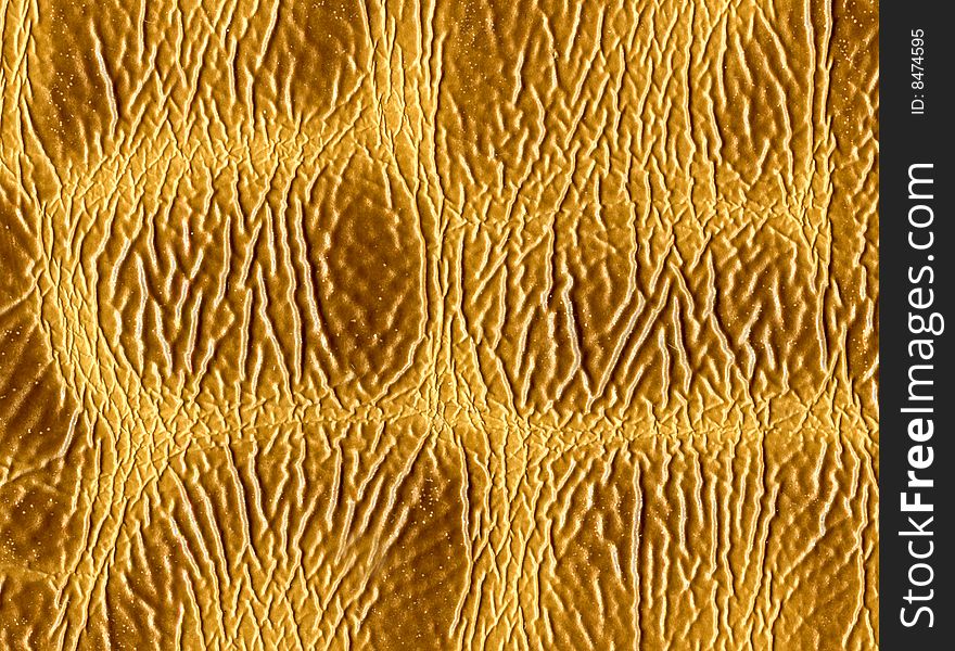 Unusual textural background from a yellow leather.