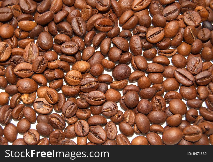 The textural background which has been laid out from brown grains of coffee. The textural background which has been laid out from brown grains of coffee.