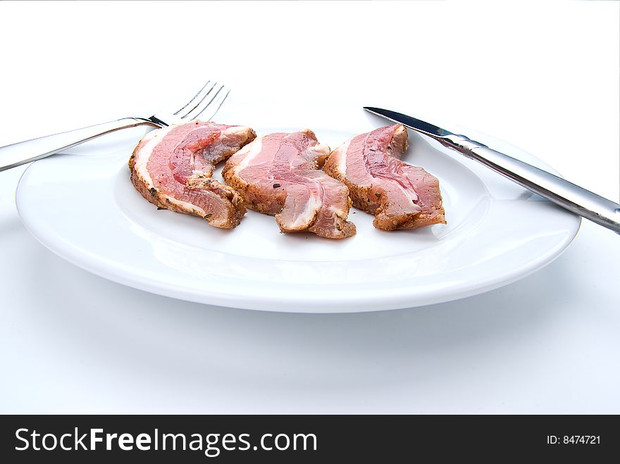 Fresh Bacon Slices Laying On White Plate