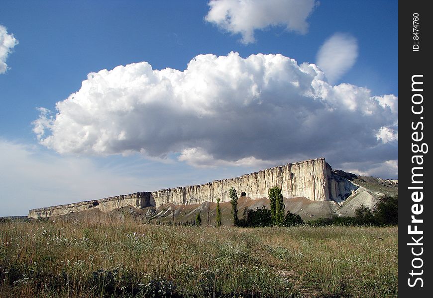 Mountainous landscape. Solitary cliff. Scenic cloud-drift. Mountainous landscape. Solitary cliff. Scenic cloud-drift.