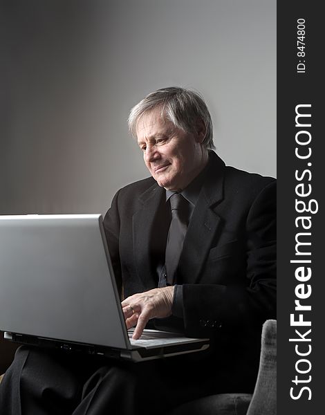 Senior businessman using a laptop