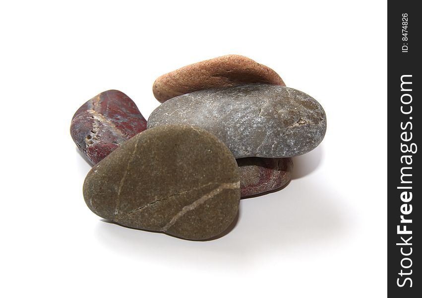 Heap colored stones for spa procedures on a white. Heap colored stones for spa procedures on a white.