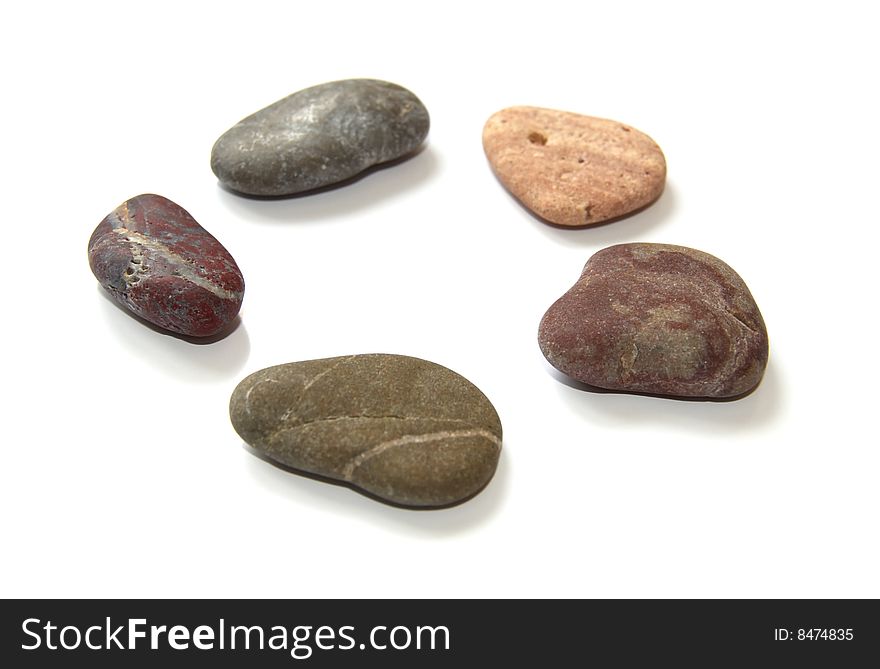 Close-up colored stones for spa procedures on a white background. Close-up colored stones for spa procedures on a white background.